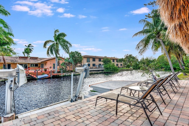 view of patio / terrace featuring a boat dock and a water view