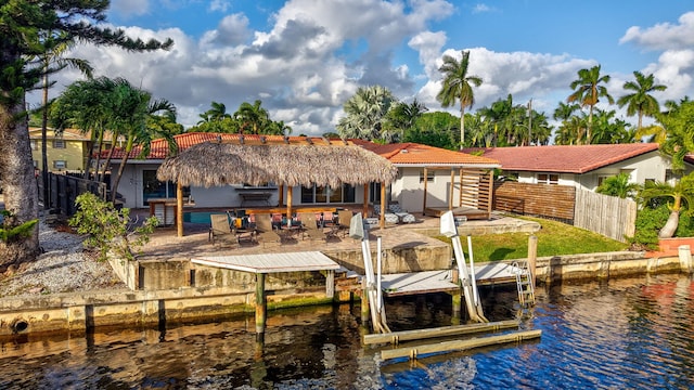 dock area with a patio area and a water view