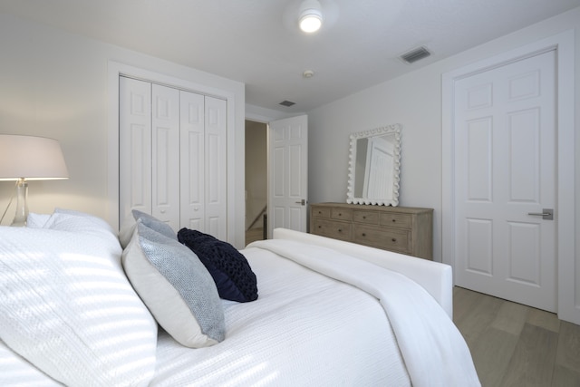 bedroom featuring hardwood / wood-style flooring and a closet