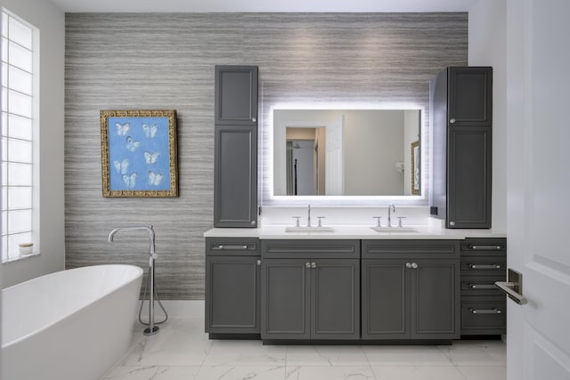 bathroom featuring vanity, plenty of natural light, and a bathtub