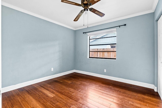 empty room with ceiling fan, crown molding, and hardwood / wood-style flooring