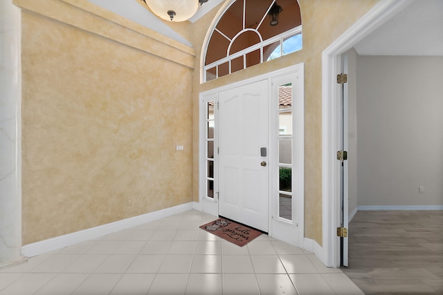 foyer entrance featuring a towering ceiling