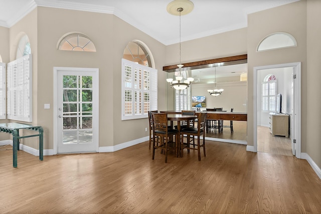 3 Via Capri, Capri, Palm Coast, FL 32137 - dining area featuring ornamental molding, baseboards, wood finished floors, and a chandelier