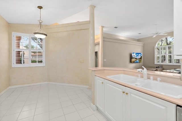 kitchen with white cabinetry, hanging light fixtures, a healthy amount of sunlight, and vaulted ceiling