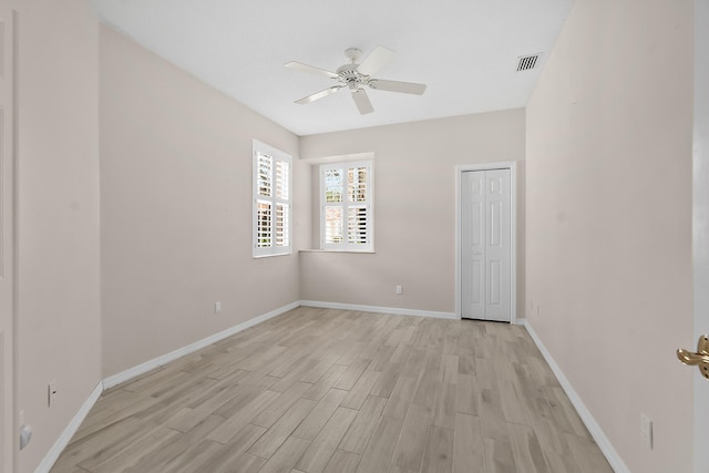 spare room featuring light hardwood / wood-style flooring and ceiling fan