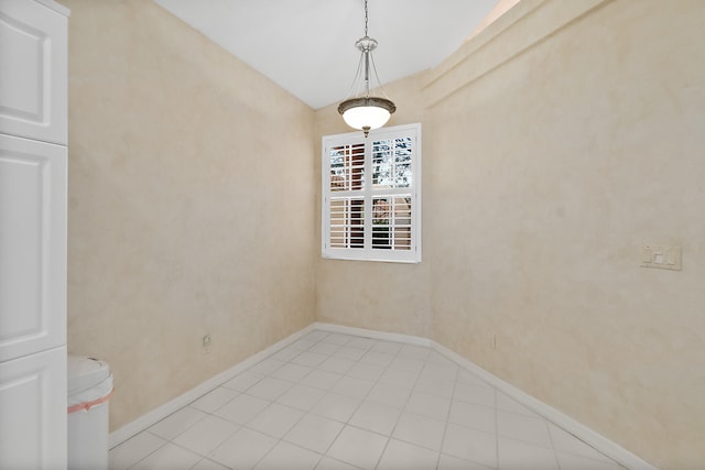 spare room featuring vaulted ceiling