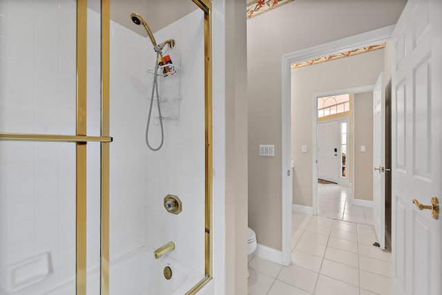 bathroom with toilet, bath / shower combo with glass door, and tile patterned floors