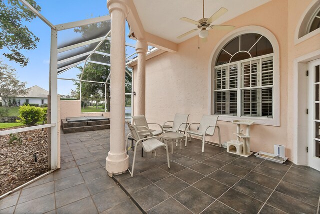 view of patio with ceiling fan and a lanai