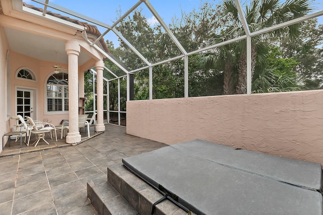 view of patio with glass enclosure and ceiling fan