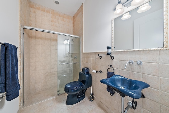 bathroom with tile patterned floors, an enclosed shower, tile walls, and toilet