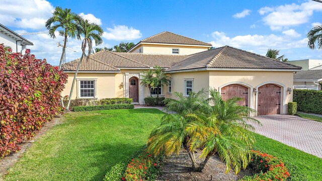 mediterranean / spanish home with a front lawn