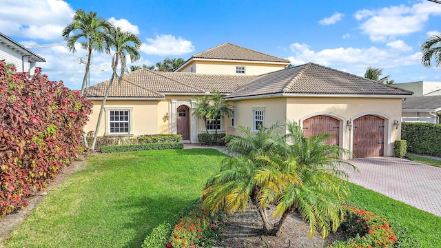 11346 Avery Rd, Palm Beach Gardens, FL 33410 - mediterranean / spanish-style home featuring a garage, decorative driveway, a tile roof, and stucco siding