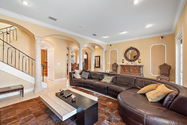 living room featuring ornate columns and crown molding