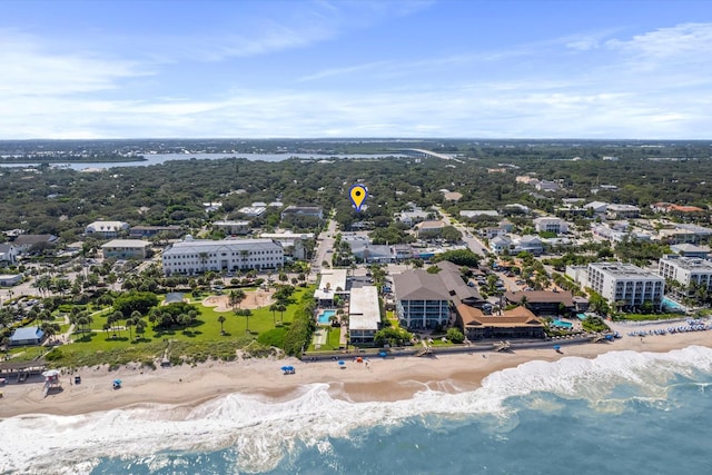 birds eye view of property featuring a beach view and a water view