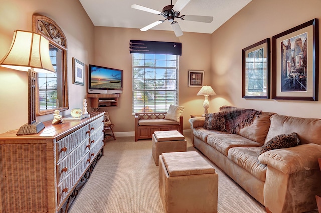 living room with ceiling fan, light colored carpet, and a healthy amount of sunlight