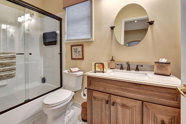 full bathroom featuring combined bath / shower with glass door, vanity, and toilet