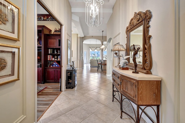 foyer entrance with a chandelier and light wood-type flooring