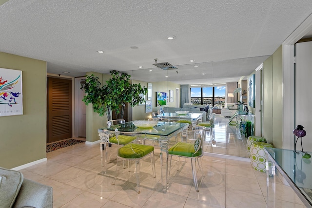 dining room with light tile patterned floors and a textured ceiling