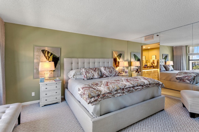 carpeted bedroom with a textured ceiling