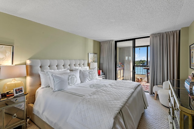 bedroom featuring a textured ceiling and access to outside