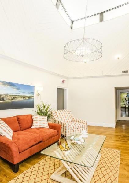 living room with wood-type flooring and a chandelier