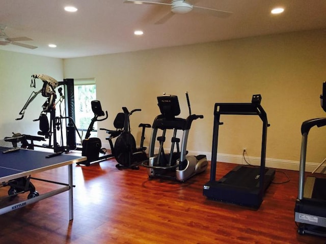 workout area with dark hardwood / wood-style flooring and ceiling fan