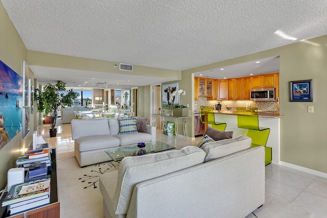 tiled living room with a textured ceiling