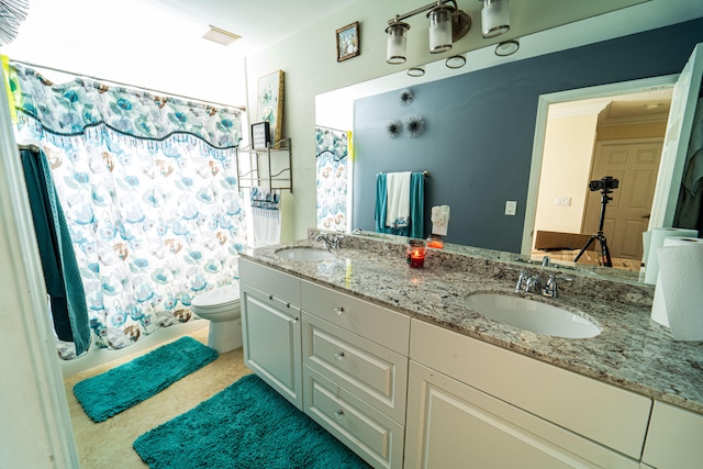 bathroom featuring vanity, toilet, ornamental molding, and walk in shower