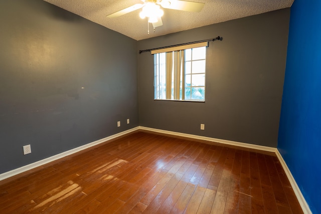 spare room with hardwood / wood-style floors, ceiling fan, and a textured ceiling