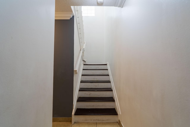 stairway featuring tile patterned flooring