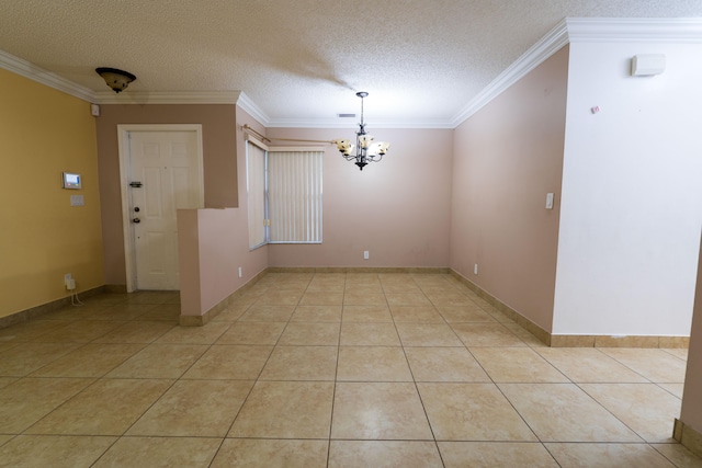 tiled empty room featuring ornamental molding, a textured ceiling, and an inviting chandelier