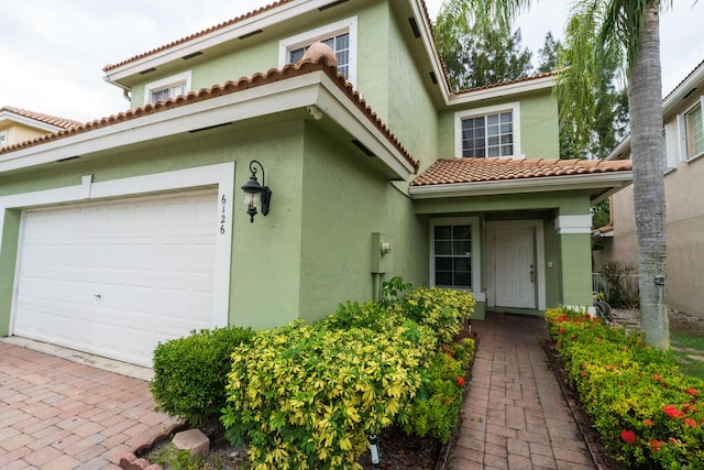 mediterranean / spanish-style home featuring a garage