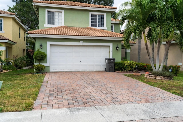 mediterranean / spanish house featuring a garage and a front lawn