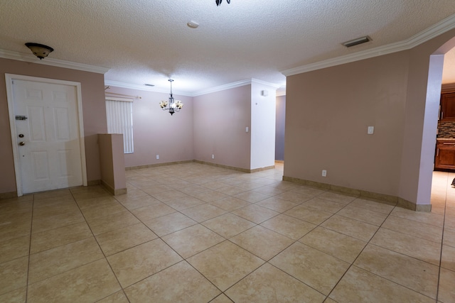 unfurnished room with light tile patterned floors, a textured ceiling, crown molding, and a notable chandelier