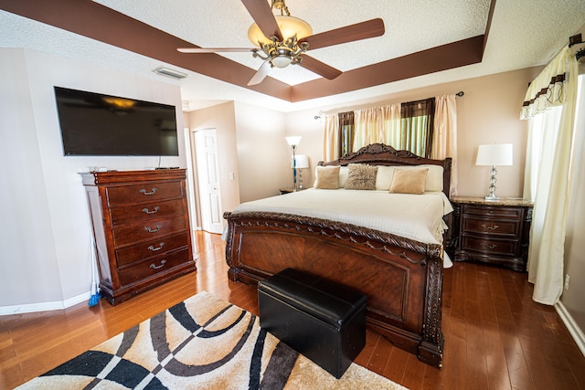 bedroom featuring wood-type flooring, a textured ceiling, and ceiling fan