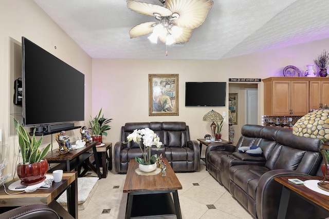 living room with a textured ceiling and ceiling fan