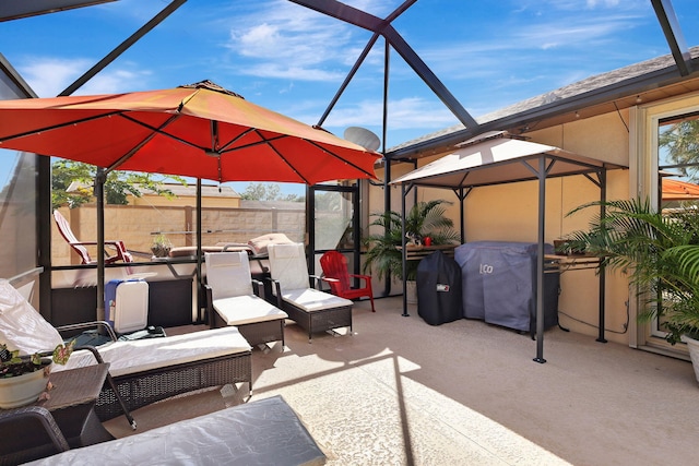 view of patio / terrace with a grill and glass enclosure