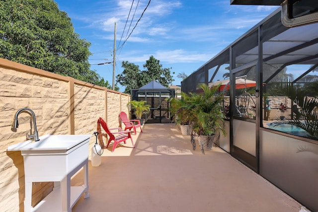 view of patio with a lanai