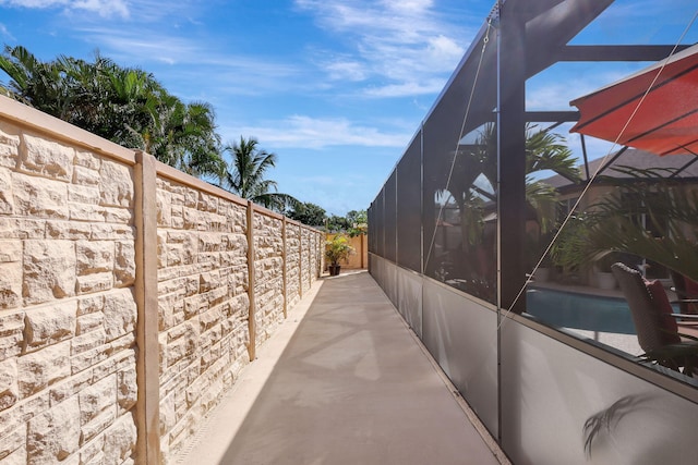 view of home's exterior with glass enclosure