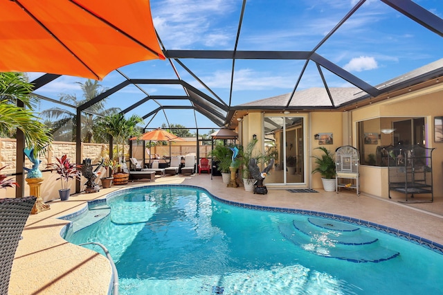 view of pool with a lanai, a patio area, and outdoor lounge area