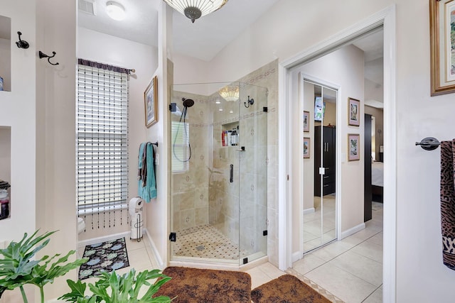 bathroom with tile patterned flooring and walk in shower