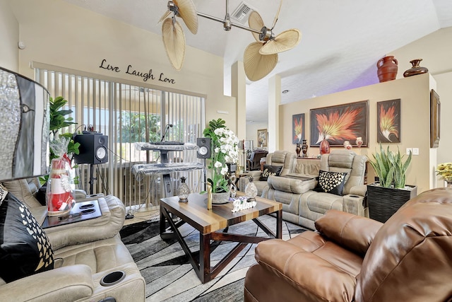 living room featuring ceiling fan and lofted ceiling