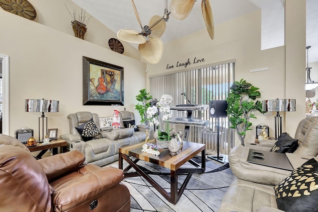 living room featuring ceiling fan and a high ceiling