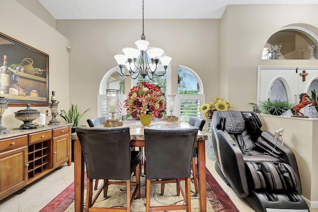 tiled dining space featuring an inviting chandelier