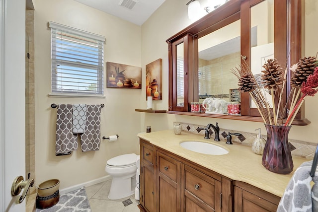 bathroom featuring toilet, vanity, and tile patterned floors