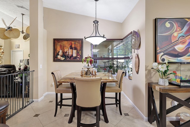 tiled dining space with lofted ceiling