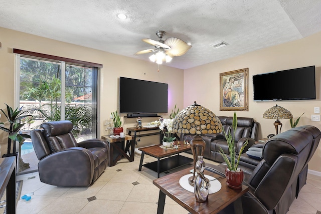 tiled living room featuring a textured ceiling and ceiling fan