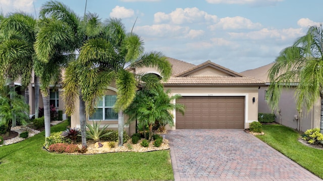 view of front of house with a garage and a front yard