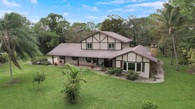 rear view of house with a patio area and a yard