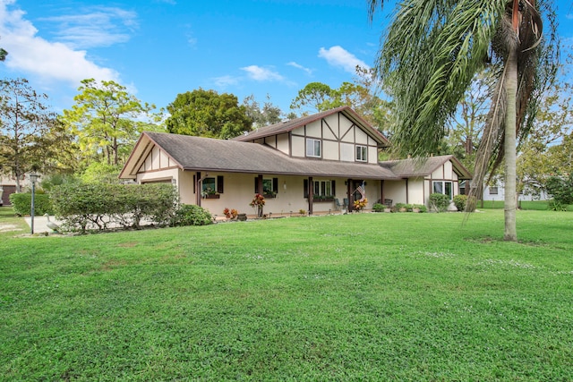 english style home featuring a front yard